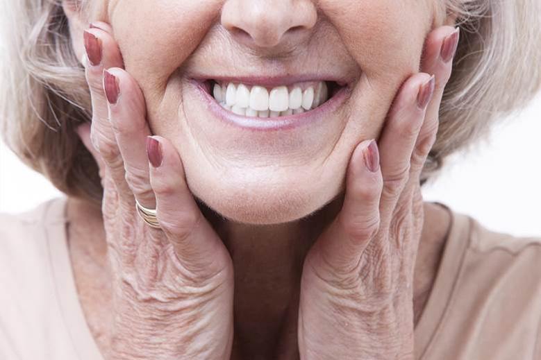 Closeup of woman smiling with dentures in Edmonton
