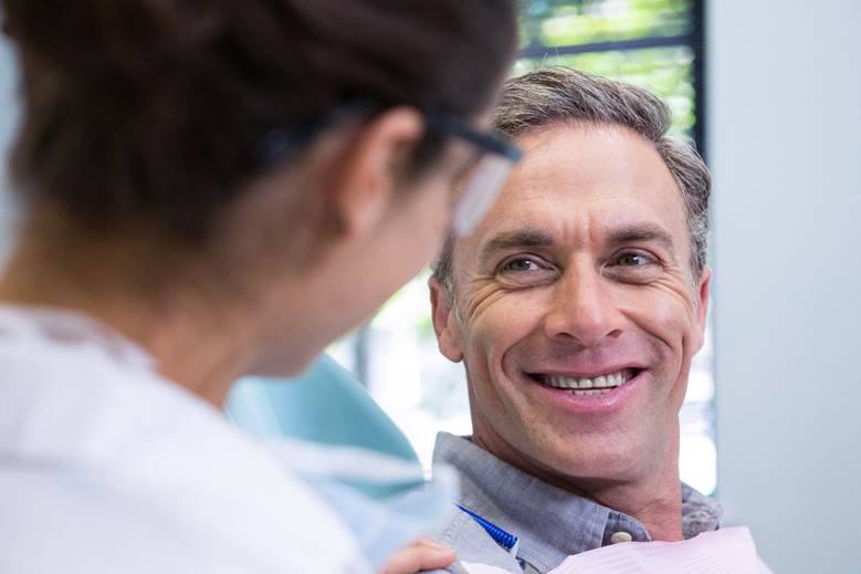 patient smiling after getting dental implants in Edmonton